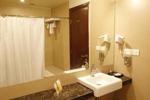 a bathroom with a sink and a shower at The Aures (formerly known as Keys Select The Aures) in Aurangabad