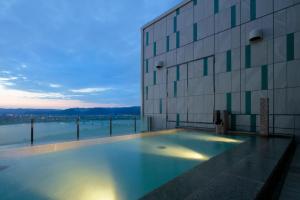 a large swimming pool in front of a large building at Candeo Hotels Nankai Wakayama in Wakayama