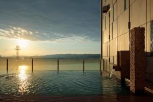 a body of water with a building in the foreground at Candeo Hotels Nankai Wakayama in Wakayama