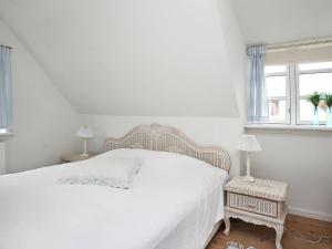 a white bedroom with a bed and a window at 5 person holiday home in Skagen-By Traum in Skagen