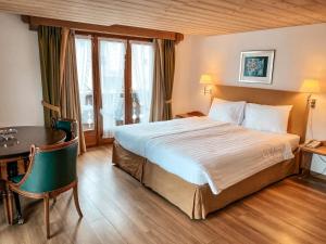 Postel nebo postele na pokoji v ubytování Hotel Steinbock