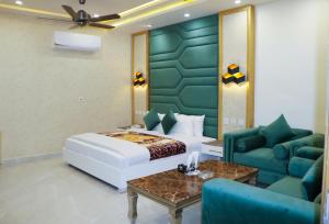 a hotel room with a bed and a couch at Hotel Avalon Suites in Multan