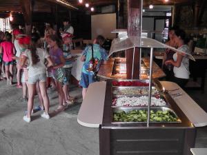 a group of children standing around a buffet of food at Festa-Kranevo in Kranevo