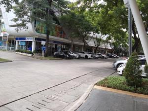 a parking lot with cars parked in front of a building at Bintang Property Aeropolis in Rawabambu