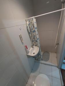 a bathroom with a sink and a toilet at Bintang Property Aeropolis in Rawabambu