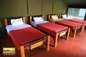 Un pat sau paturi într-o cameră la Camp Mahon Gardens
