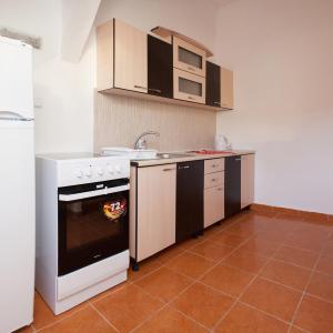 a kitchen with a white stove and a sink at Premier Apartment in Satu Mare