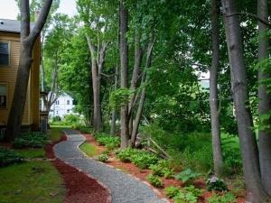 a winding path in a yard next to a house at The Fairlawn Inn in Hunter