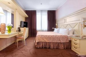a hotel room with a bed and a desk at Milan Hotel Moscow in Moscow
