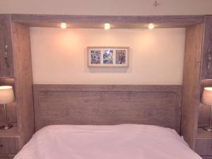 a bedroom with a bed with two lights above it at The Royal Luxury King Terrace 1 in Amman
