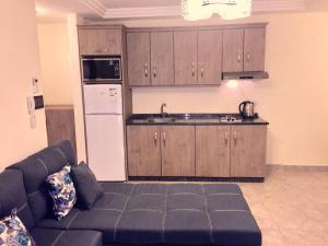 a living room with a couch and a kitchen at The Royal Luxury King Terrace 1 in Amman +24 photos