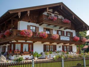 a building with flowerpots on the balconies of it at Haus Thanner - Chiemgau Karte in Inzell