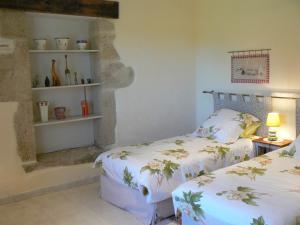 Saint-Martin-de-GurçonにあるDomaine de Genevieve des vignesの石壁のベッドルーム1室(ベッド2台付)