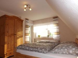 a bedroom with two beds and a window at Ferienwohnung Wallensiepen in Schmallenberg