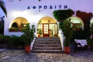 a white building with stairs leading to a door at Afroditi in Panormos Skopelos