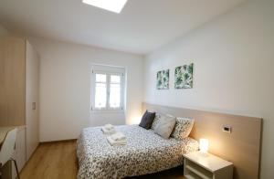 Postel nebo postele na pokoji v ubytování Conte Durini Apartments & Rooms