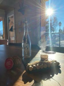 a bottle on a table with some snacks on it at Bim See in Bettmeralp