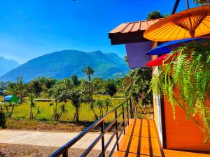a balcony of a house with a view of a mountain at Ban Thung Talay Mok Chiangdao in Chiang Dao