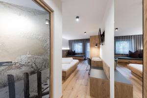 a living room with a sliding glass door leading into a living room at Hotel Am Fels in Senales