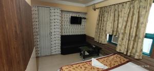 a small room with a bed and a window at Hotel Royal Residency in Siliguri