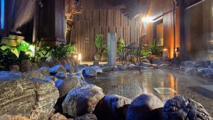 a pool of water with rocks in a room at Dormy Inn Akihabara in Tokyo