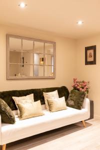 a couch in a living room with a window at Chic Apartments Barcelona in Barcelona