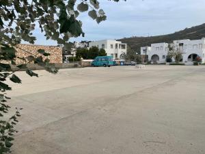 a large parking lot with a blue van parked in it at Patmos Villas in Grikos