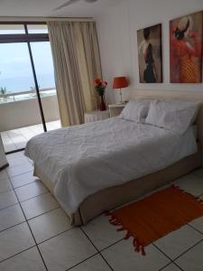 a bedroom with a bed and a view of the ocean at Mont Blanc 29 in Margate