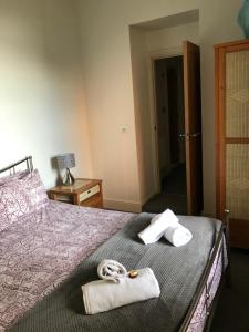 a bedroom with a bed with towels on it at Southover Beach in Woolacombe