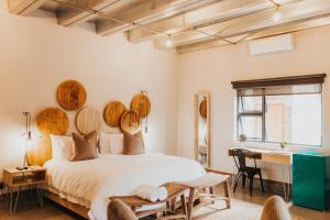 a bedroom with a bed with wooden plates on the wall at Execustay in Nelspruit