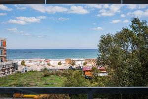 a view of the beach from a balcony at Blue Boutique Magic View of the Sea Apartments in Mamaia