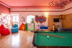 a billiard room with a pool table in it at MyTime Hotels Savoy in Vigo di Fassa