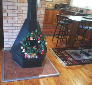 a christmas tree in front of a fire place at Clarens Eddies Guest house in Clarens