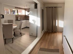 uma cozinha com um frigorífico branco e uma mesa em Hagavägen 1 Lägenhet em Grebbestad