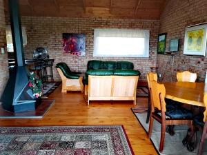 a living room with a couch and a table at Clarens Eddies Guest house in Clarens