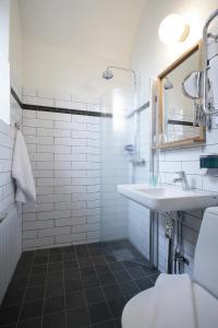 a bathroom with a sink, toilet and bathtub at Långholmen Hotell in Stockholm