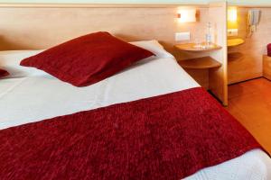 a bedroom with a bed with a red blanket on it at Hotel Xaine Park in Lloret de Mar