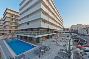 an overhead view of a building with a swimming pool at Mercure Rhodes Alexia Hotel & Spa in Rhodes Town
