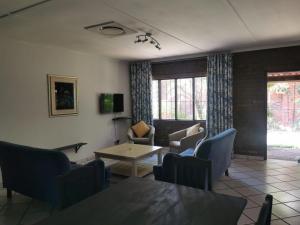 a living room with a table and chairs at The Dunes in St Lucia