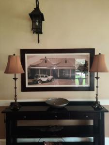 a picture of a car on a wall with two lamps at Villa Beryl Guesthouse in Vryheid