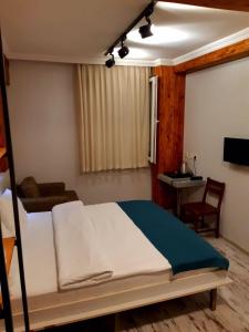 a bedroom with a bed and a desk and a television at Hot Budget Ortakoy in Istanbul