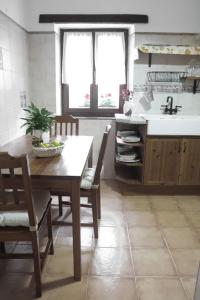 a kitchen with a table and chairs and a sink at Arriola Txiki in Itziar