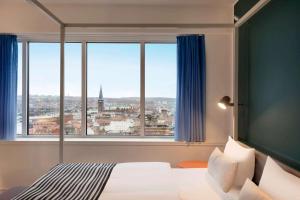 A bed or beds in a room at Comwell Aarhus Dolce by Wyndham