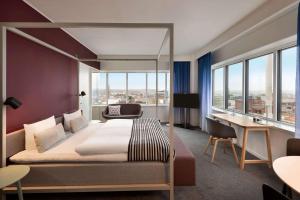 A bed or beds in a room at Comwell Aarhus Dolce by Wyndham