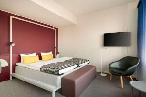 A bed or beds in a room at Comwell Aarhus Dolce by Wyndham