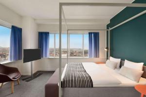 A bed or beds in a room at Comwell Aarhus Dolce by Wyndham