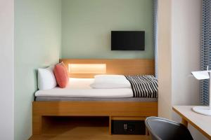A bed or beds in a room at Comwell Aarhus Dolce by Wyndham