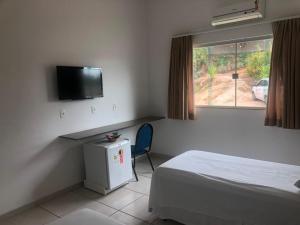 Ένα ή περισσότερα κρεβάτια σε δωμάτιο στο Jequitiara Hotel