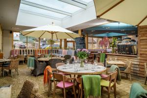 a dining room with tables and chairs and an open at The Castle Inn in Harrogate