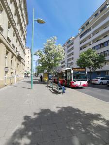 a bus is parked on a street with at Apartments Hellwagstraße in Vienna